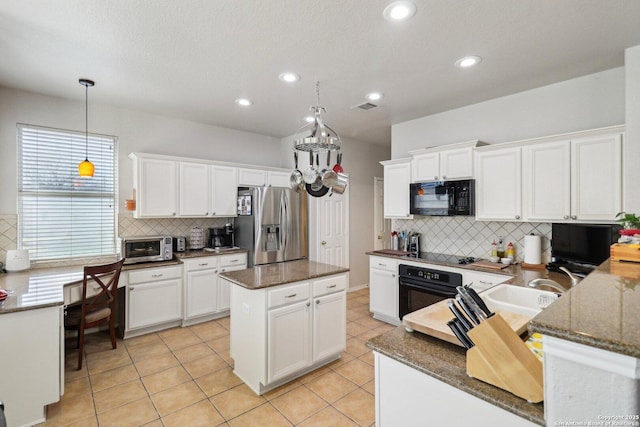 kitchen featuring white cabinetry, black appliances, light tile patterned floors, and visible vents