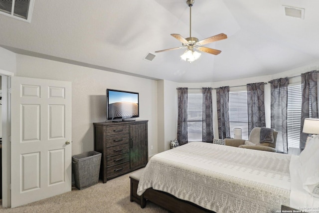 bedroom with visible vents, light colored carpet, and lofted ceiling