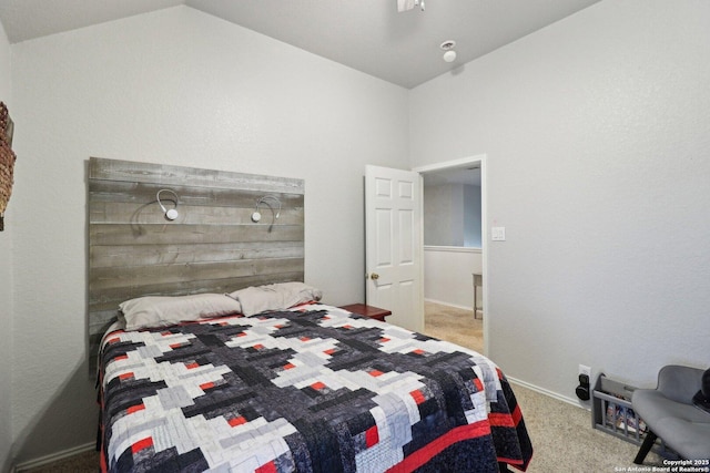 carpeted bedroom with ceiling fan and vaulted ceiling