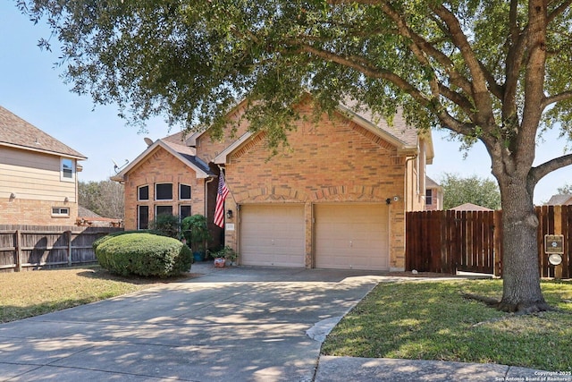 traditional home featuring brick siding, concrete driveway, an attached garage, and fence