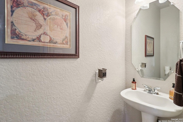 bathroom with a sink and a textured wall