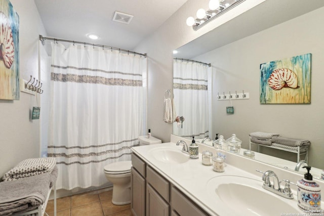 bathroom featuring tile patterned flooring, visible vents, toilet, and a sink