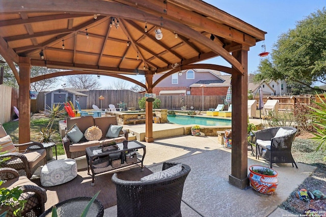 view of patio with an outbuilding, a fenced backyard, a gazebo, a storage shed, and an outdoor hangout area