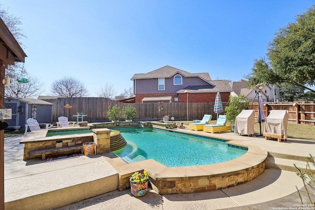 view of pool with an in ground hot tub, a fenced backyard, a fenced in pool, and a patio area