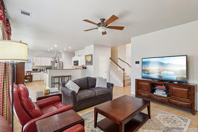 living area featuring stairway, visible vents, light tile patterned flooring, recessed lighting, and ceiling fan