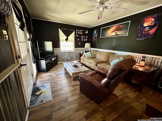 living room with ceiling fan, wood finished floors, and crown molding