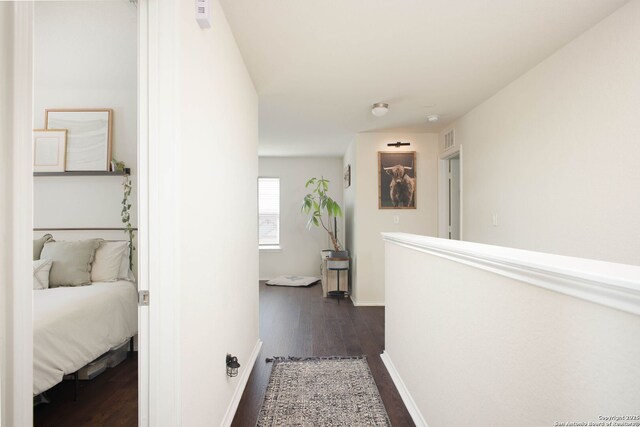 7611 Ponderosa Pne, Boerne, TX 78015 - hallway featuring baseboards, visible vents, and dark wood-style flooring
