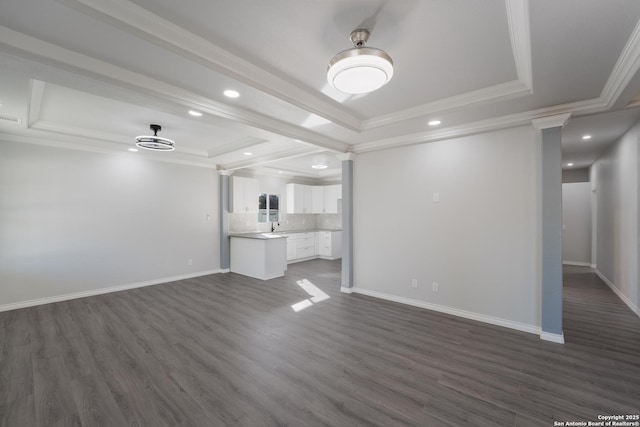 unfurnished living room featuring a tray ceiling, dark wood-style floors, and ornamental molding