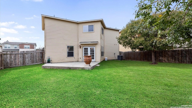 rear view of property with a patio, a yard, and a fenced backyard