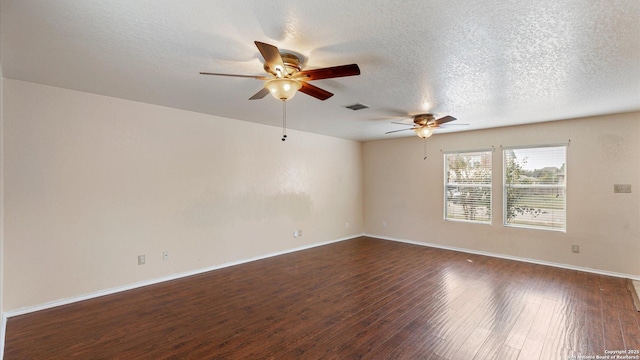 unfurnished room featuring dark wood finished floors, visible vents, a textured ceiling, and baseboards