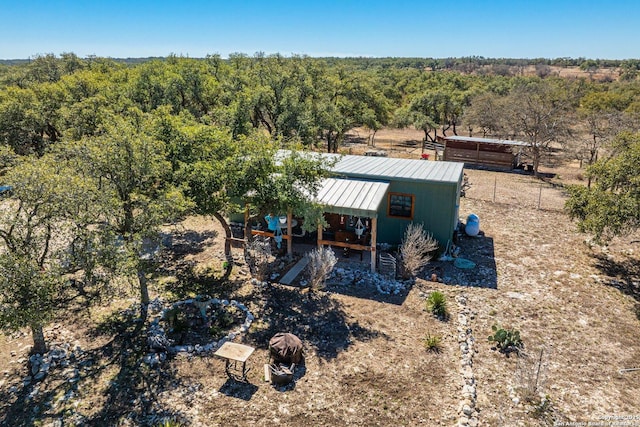 birds eye view of property featuring a view of trees