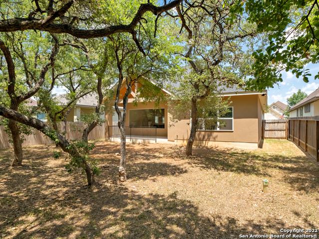 back of property featuring a fenced backyard and stucco siding