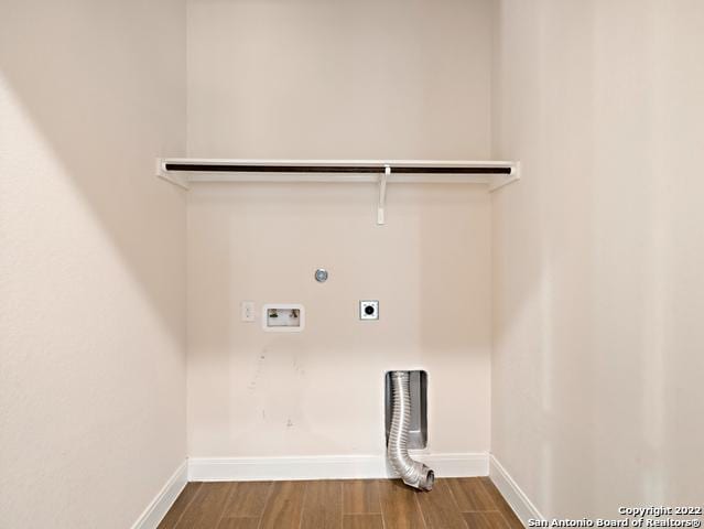 laundry area featuring washer hookup, wood finished floors, baseboards, hookup for an electric dryer, and laundry area