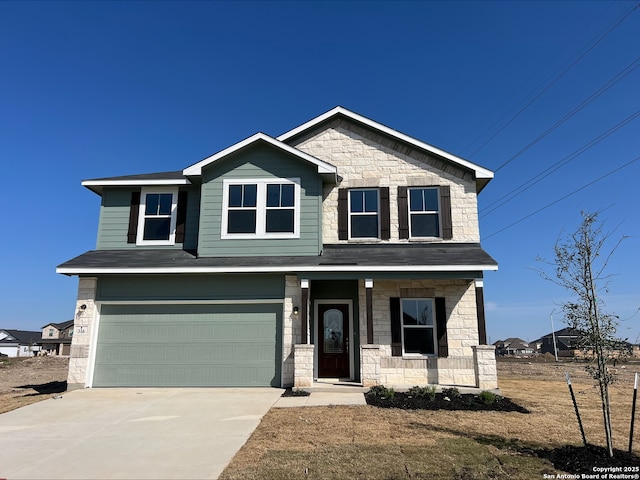 craftsman-style home featuring concrete driveway, an attached garage, covered porch, and stone siding