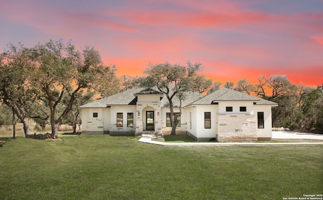 view of front of house featuring a front lawn and stone siding