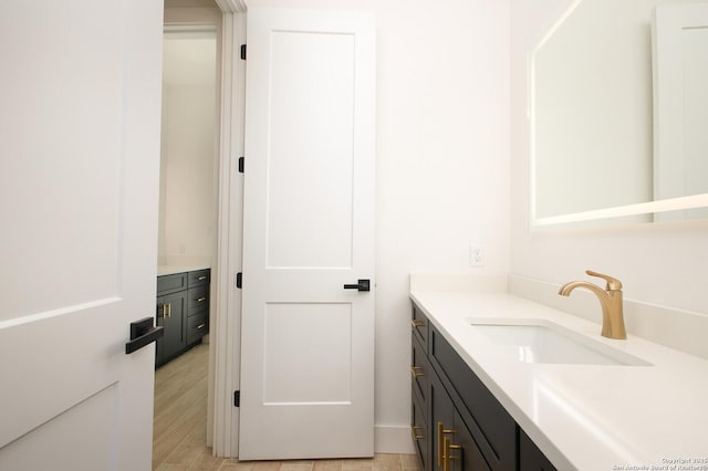 bathroom featuring vanity and wood finished floors