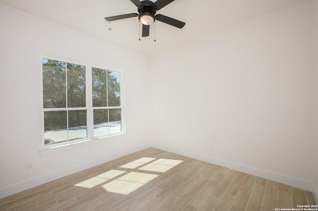 spare room with light wood-style floors, baseboards, and ceiling fan