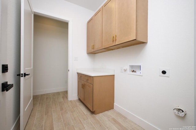 washroom with hookup for a washing machine, baseboards, hookup for an electric dryer, wood finish floors, and cabinet space