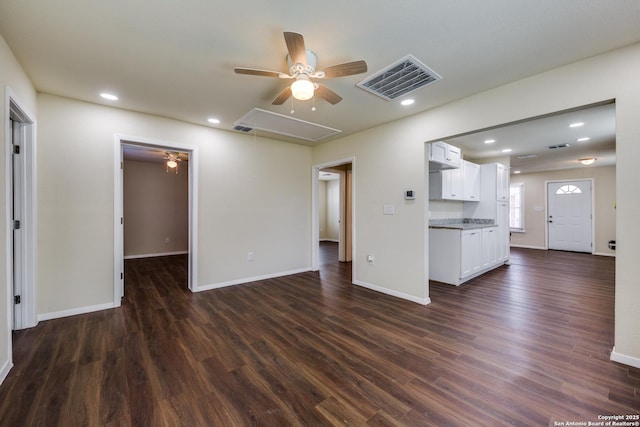 unfurnished living room featuring recessed lighting, visible vents, attic access, and dark wood-style flooring