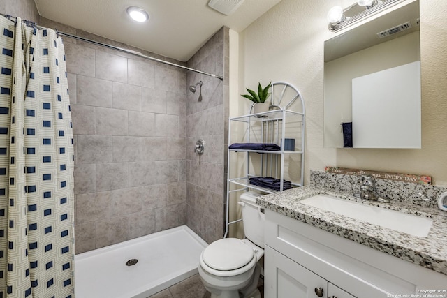 full bathroom with visible vents and tiled shower