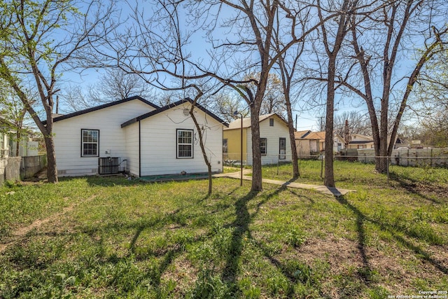 back of property with a yard, fence private yard, and cooling unit