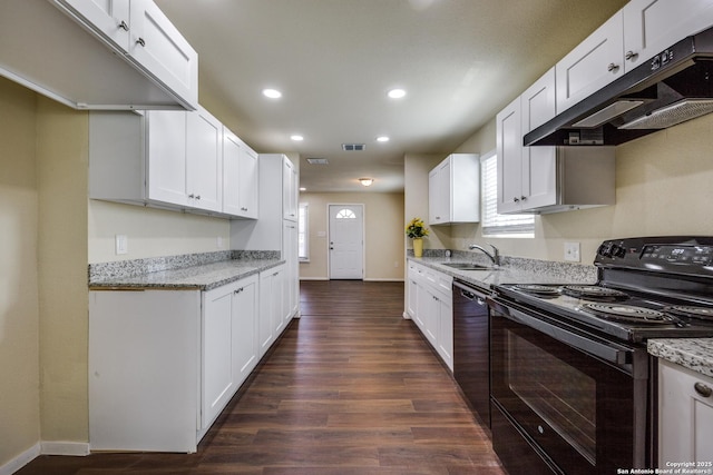 kitchen with visible vents, black appliances, under cabinet range hood, a sink, and dark wood-style floors