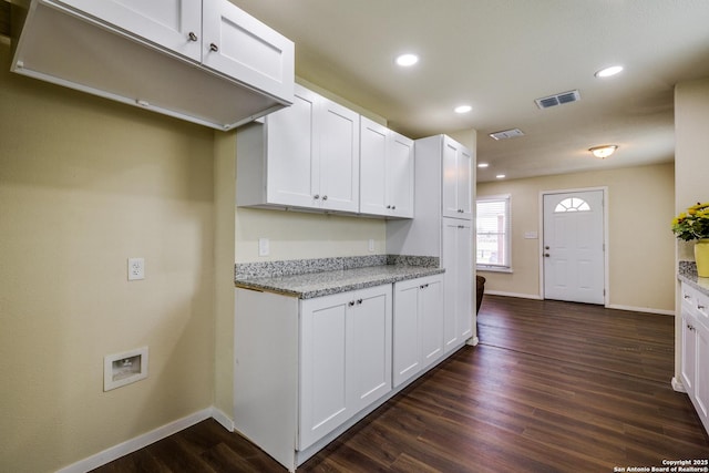 kitchen with dark wood finished floors, baseboards, and white cabinetry