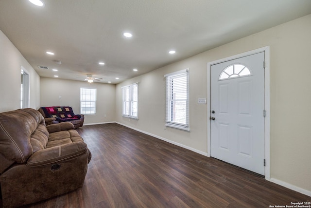 living area featuring visible vents, recessed lighting, baseboards, and dark wood-style flooring