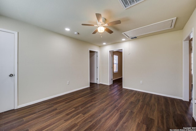 spare room with visible vents, baseboards, attic access, recessed lighting, and dark wood-style flooring