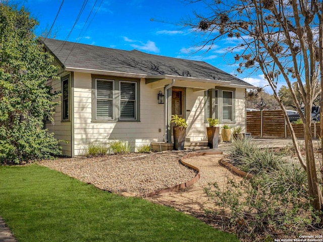 view of front of home featuring a front lawn and fence