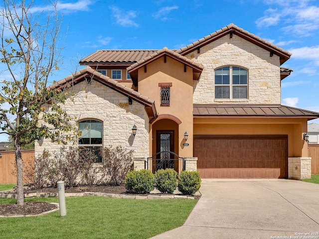 mediterranean / spanish home with stucco siding, a standing seam roof, fence, concrete driveway, and a garage