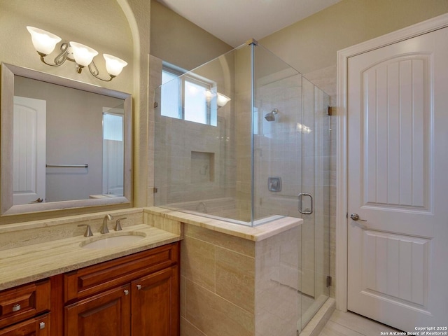 bathroom with vanity and a shower stall