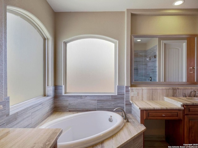 full bathroom featuring recessed lighting, tiled shower, vanity, and a garden tub