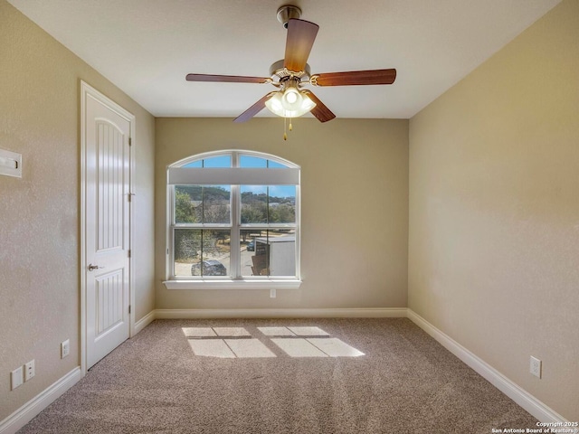 unfurnished room featuring ceiling fan, baseboards, and carpet floors