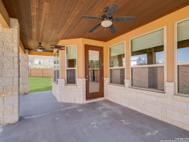 view of patio with ceiling fan and fence