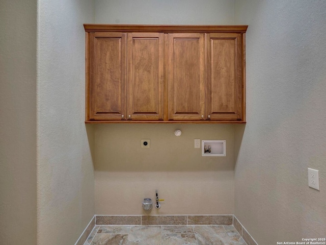 clothes washing area featuring hookup for a washing machine, baseboards, gas dryer hookup, cabinet space, and electric dryer hookup