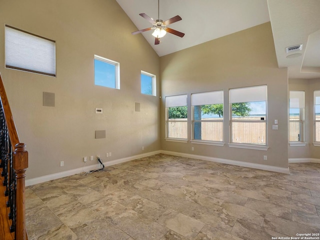 unfurnished living room featuring visible vents, ceiling fan, baseboards, stairs, and high vaulted ceiling