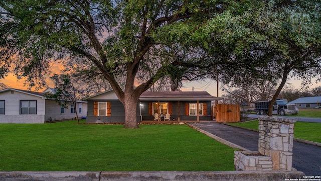 view of front facade featuring a lawn and a porch