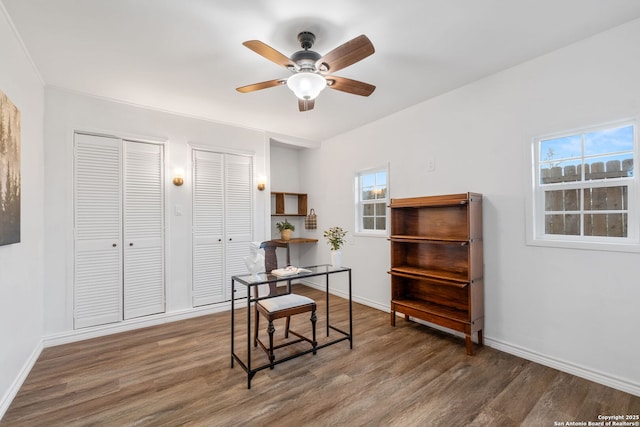 office featuring a ceiling fan, wood finished floors, and baseboards