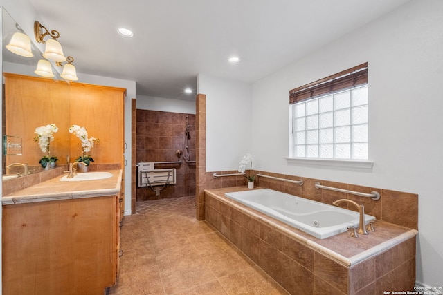 bathroom featuring vanity, a bath, recessed lighting, and walk in shower