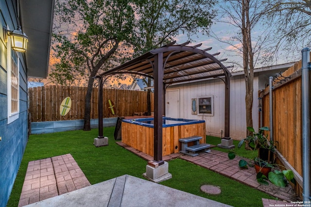 yard at dusk featuring a patio, a hot tub, a fenced backyard, and a pergola