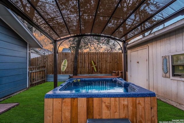 view of swimming pool featuring a yard, a hot tub, a pergola, and fence