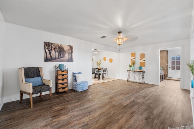 sitting room featuring visible vents, baseboards, and wood finished floors