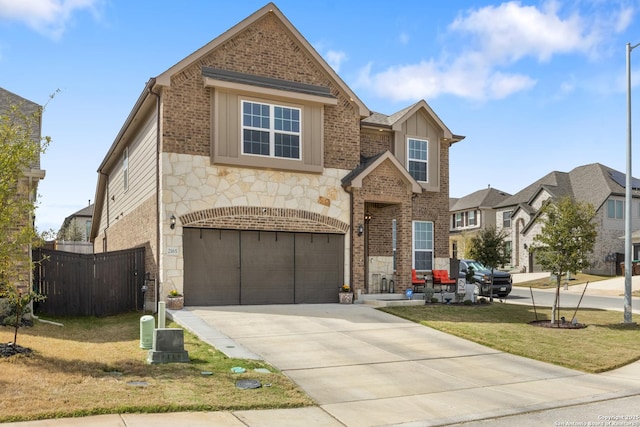 view of front facade featuring a front lawn, brick siding, concrete driveway, and an attached garage