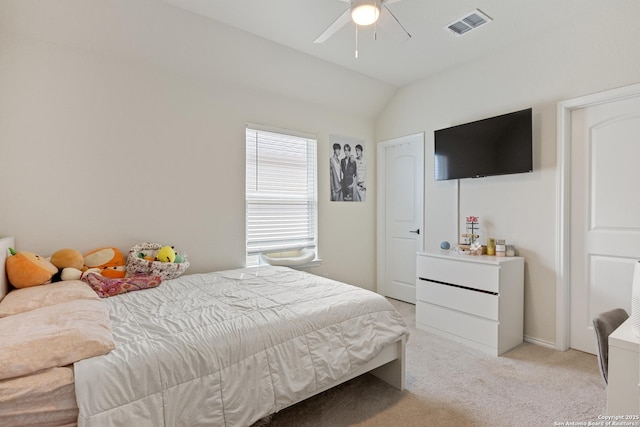 bedroom with visible vents, light colored carpet, ceiling fan, and vaulted ceiling