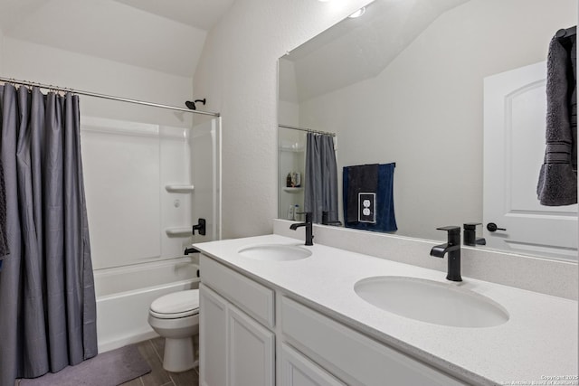 bathroom featuring double vanity, toilet, shower / bath combo with shower curtain, and a sink