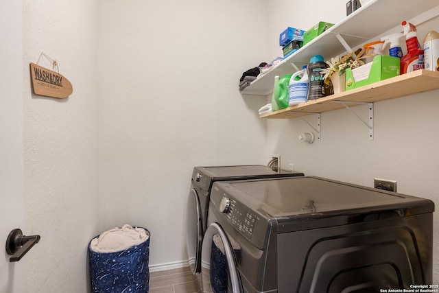 laundry room with laundry area, dark wood-style floors, and washer and clothes dryer