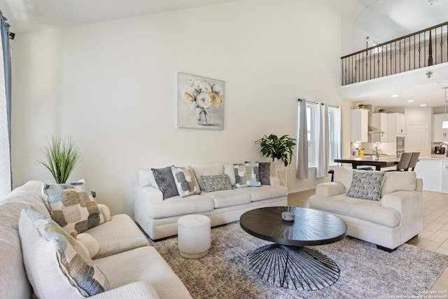 living room with a high ceiling and light wood finished floors