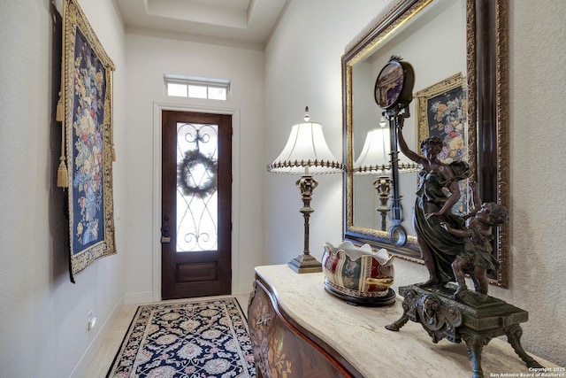 foyer with baseboards and a wealth of natural light