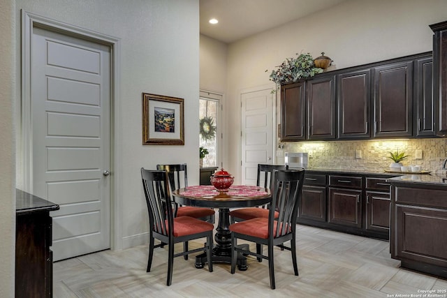 dining space featuring recessed lighting and baseboards